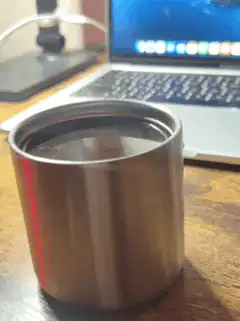 steaming metal cup on desk