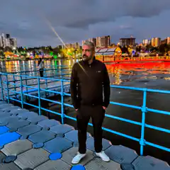 Man standing on dock at night