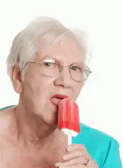 Old woman licking red popsicle