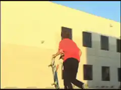Skateboarder kicks cup out of friend's hand