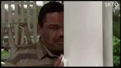 Man peeking from behind a pillar