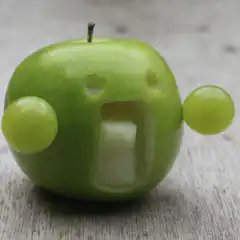 Green apple with grape arms and screaming mouth