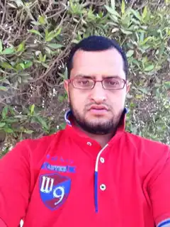 Man in red polo shirt with glasses