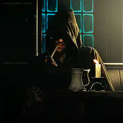 hooded man smoking by candlelight
