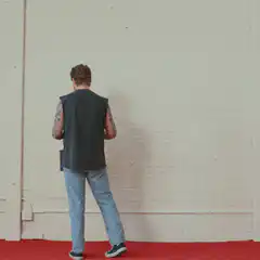 man painting red square on wall
