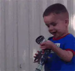 Toddler sprays water bottle and laughs