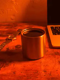 coffee cup on desk with laptop