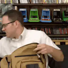 Man struggles to fit rifle in backpack