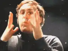 John Lennon making magic with his hands