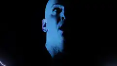 Bald man looks up at lightning