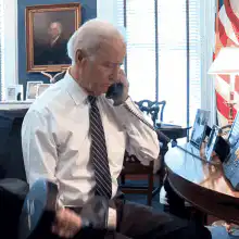 Joe Biden lifting weights on the phone