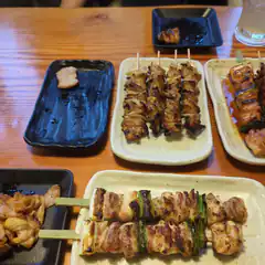 assorted grilled skewers on plates