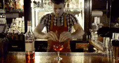 Bartender garnishes a cocktail