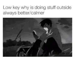 Anime boy sitting outside at night with phone