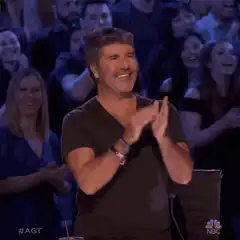 Simon Cowell clapping and smiling