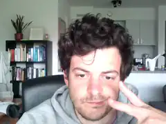 man holding peace sign near face