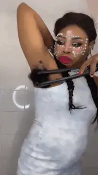 Woman uses hair straightener on armpit hair