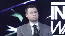 Man in suit nodding and blinking