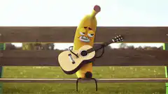 Banana playing guitar on a park bench