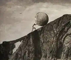 man pushing giant moon up cliff