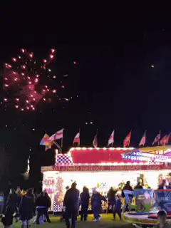 fireworks over carnival ride