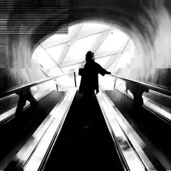 Silhouette on escalator in tunnel