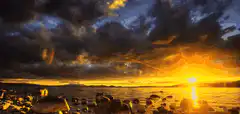 dramatic sunset over rocky shore