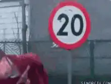 man throws speed limit sign