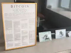 Bitcoin whitepaper framed on desk