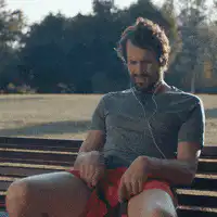 Man on bench looks at woman on bike