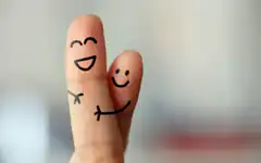 two fingers with drawn faces