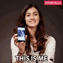 Woman showing phone with THIS IS ME caption