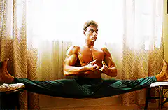 Muscular man doing splits