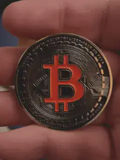 Bitcoin coin in hand