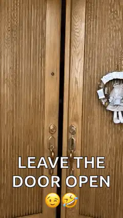 Man opens double doors with heart shirt