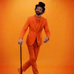 Man in orange suit dancing with cane