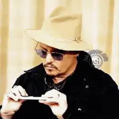 Johnny Depp holds fake mustache