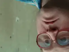 Close up of a boy with glasses looking up