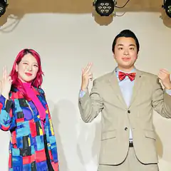Man and woman posing with peace signs