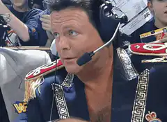 Jim Ross smirking and laughing