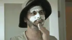 Man applying white face mask