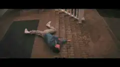 man lying on brick steps