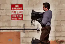 Jim throws a TV in a dumpster