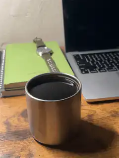 coffee cup on desk with laptop