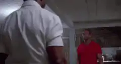Arnold Schwarzenegger and Sylvester Stallone arm wrestle