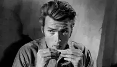 Clint Eastwood playing harmonica
