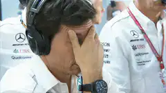 Man in Mercedes shirt facepalms