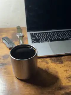 coffee cup on desk with laptop