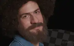 Man with beard and afro makes ok sign