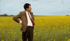 Man in field checks watch
